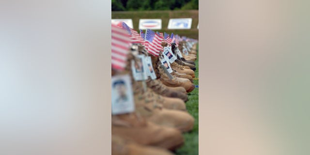 To set up the memorial boot display, volunteers carefully tie each lace and place an empty water bottle inside each boot to keep it erect.