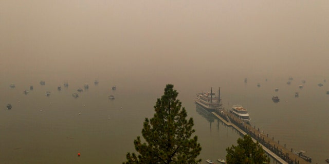 Smoke from the Caldor Fire fills the sky above Lake Tahoe's Zephyr Cove in Douglas County, Nev., on Friday, Aug. 27, 2021.
