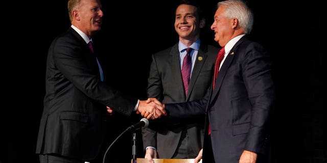 Republican gubernatorial recall candidates, former San Diego Mayor Kevin Faulconer, left, Assemblyman Kevin Kiley, center and businessman John Cox, right, gather together after their debate held by the Sacramento Press Club in Sacramento, Calif., Tuesday, Aug. 17, 2021. (AP Photo/Rich Pedroncelli)