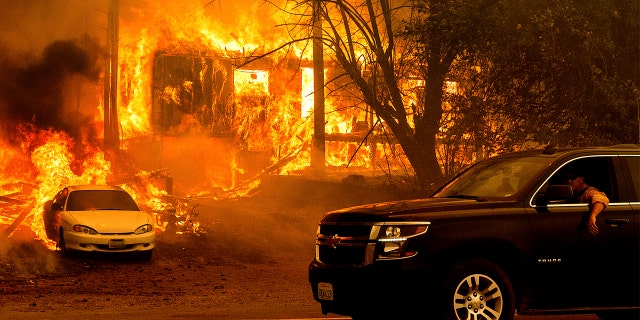 Flames from the Dixie Fire consume a home on Highway 89 south of Greenville on Thursday, Aug. 5, 2021, in Plumas County, Calif.