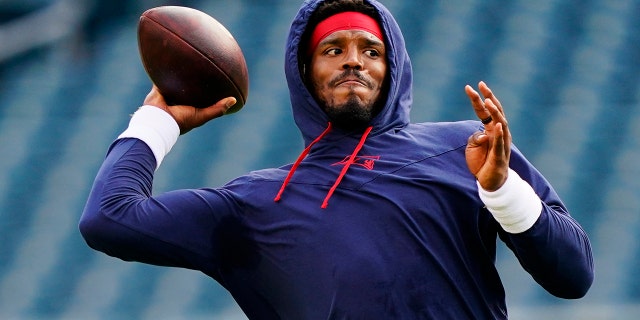 New England Patriots' Cam Newton warms up before a preseason NFL football game Philadelphia Eagles on Thursday, Aug. 19, 2021, in Philadelphia. (AP Photo/Matt Rourke)