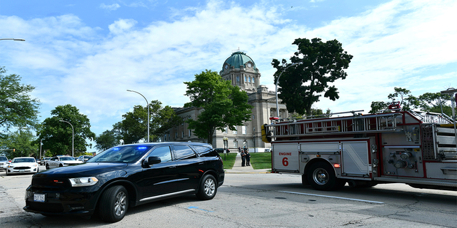 Kankakee Police and fire blockade the area of East Merchant Street following a shooting near the Kankakee County Courthouse, Thursday morning, Aug. 26, 2021, in Kankakee, Ill. Two people were killed and another was injured Thursday morning, Mayor Christopher Curtis said.