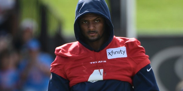 Texans quarterback Deshaun Watson (4) wipes his hands after stretching during NFL football practice Saturday, July 31, 2021, in Houston.