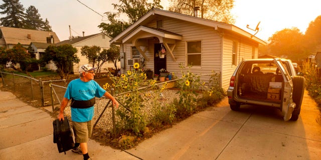 As the Dixie Fire burns towards Susanville, Calif., Gary Mooney prepares to evacuate from his home on Monday, Aug. 16, 2021.