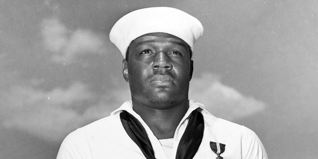Après avoir reçu la Navy Cross par l'amiral Chester W. Nimitz, à bord de l'USS Enterprise (CV-6) à Pearl Harbor, le 27 mai 1942. La médaille a été décernée pour l'héroïsme à bord de l'USS West Virginia (BB-48) pendant le Pearl Attaque du port, 7 décembre 1941. Photographie officielle de l'US Navy, maintenant dans les collections des Archives nationales.