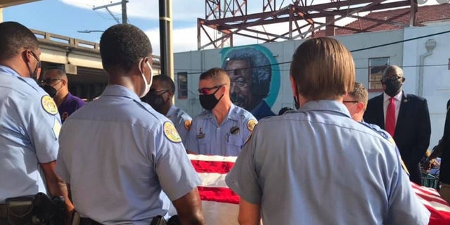 New Orleans police officers hold a casket with Det. Everett Briscoe's body. Briscoe was killed this past weekend while visiting Houston with members of the Zulu Social Aid and Pleasure Club.