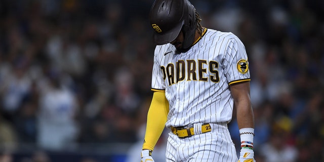 San Diego Padres center fielder Fernando Tatis Jr. (23) walks to the dugout after striking out during the fourth inning against the Los Angeles Dodgers at Petco Park. Mandatory Credit: Orlando Ramirez-USA TODAY Sports