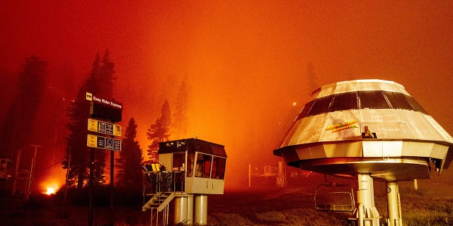 Flames surround a chair lift at Sierra-at-Tahoe Resort, a skiing area, during the Caldor fire in Twin Bridges, California on August 30, 2021. (Photo by JOSH EDELSON / AFP) (Photo by JOSH EDELSON/AFP via Getty Images)