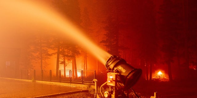A snow gun sprays water at the Sierra-at-Tahoe Resort during the Caldor fire in Twin Bridges, California on August 30, 2021.