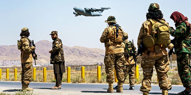 A C-17 Globemaster takes off as Taliban fighters secure the outer perimeter, alongside the American controlled side of the Hamid Karzai International Airport in Kabul, Afghanistan, Sunday, Aug. 29, 2021. (MARCUS YAM / LOS ANGELES TIMES)