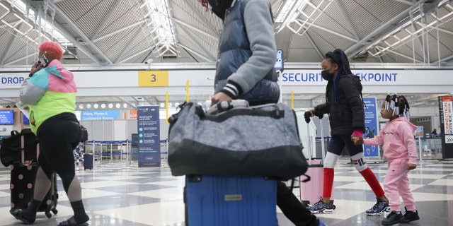 Travelers arrive for flights at O'Hare international Airport on March 16, 2021 in Chicago, Illinois. (Photo by Scott Olson/Getty Images)