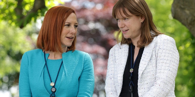 WASHINGTON, DC - MAY 13: Former White House Press Secretary Jen Psaki (L) and White House Communications Director Kate Bedingfield (R) wait for President Joe Biden to deliver remarks on the COVID-19 response and vaccination program in the Rose Garden of the White House on May 13, 2021 in Washington, DC.  Psaki left her post earlier this year;  Bedingfield is due to depart soon.