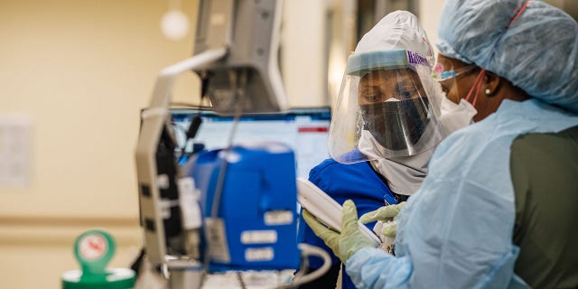 Emergency Room nurses speak to each other at the Houston Methodist The Woodlands Hospital on August 18, 2021, in Houston, Texas.