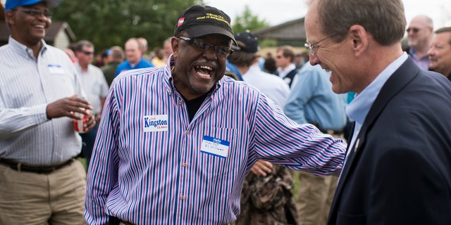Former Candidate for U.S. Senate Rep. Jack Kingston, R-Ga., right, speaks with Georgia State Representative Al Williams at the Law Enforcement Cookout at Wayne Dasher's pond house in Glennville, Ga., on Thursday, April 17, 2014. (Photo By Bill Clark/CQ Roll Call)