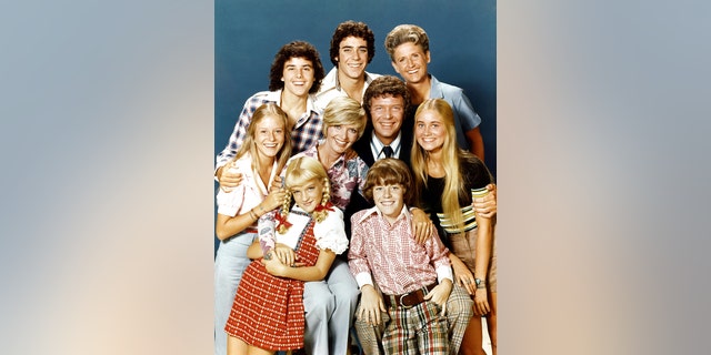 Pictured, top row: Christopher Knight (Peter), Barry Williams (Greg), Ann B. Davis (Alice); middle row: Eve Plumb (Jan), Florence Henderson (Carol), Robert Reed (Mike), Maureen McCormick (Marcia); bottom row: Susan Olsen (Cindy), Mike Lookinland (Bobby).
