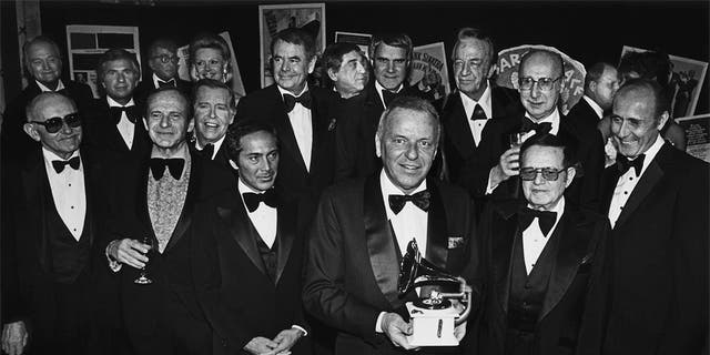 Singer Frank Sinatra (front center) holds a Grammy Awards as he is honored by celebrity friends Paul Anka, Glenn Ford, Phil Harris, Rich Little, Red Skelton, Julie Styne, Dean Martin, Dina Merrill and Henry Mancini during a 1979 banquet at Cesear's Palace in Las Vegas, Nev. 