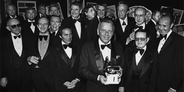 Singer Frank Sinatra (front center) holds a Grammy Awards as he is honored by celebrity friends Paul Anka, Glenn Ford, Phil Harris, Rich Little, Red Skelton, Julie Styne, Dean Martin, Dina Merrill and Henry Mancini during a 1979 banquet at Cesear's Palace in Las Vegas, Nev.