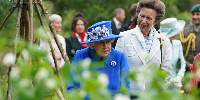 Queen Elizabeth II and Princess Anne, Princess Royal, visit the Children's Wood Project, a community project in Glasgow as part of her traditional trip to Scotland for Holyrood Week on June 30, 2021, in Glasgow, Scotland. The visit marked the 95-year-old's first official visit north of the border since the death of her husband, the Duke of Edinburgh.