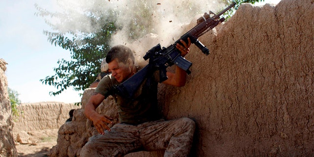 FILE PHOTO: Sgt. William Olas Bee, a U.S. Marine from the 24th Marine Expeditionary Unit, has a close call after Taliban fighters opened fire near Garmser in Helmand Province of Afghanistan May 18, 2008.  The Marine was not injured. REUTERS/Goran Tomasevic/File Photo