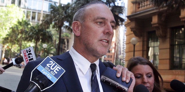 In this Oct. 7, 2014, photo, founder of the Sydney-based global Hillsong Church Brian Houston leaves a Royal Commission into Institutional Responses to Child Sexual Abuse hearings in Sydney, Australia. Houston has been charged with concealing child sex offenses, police said on Thursday, Aug. 5, 2021. 