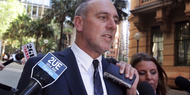 In this Oct. 7, 2014, photo, founder of the Sydney-based global Hillsong Church Brian Houston leaves a Royal Commission into Institutional Responses to Child Sexual Abuse hearings in Sydney, Australia. Houston has been charged with concealing child sex offenses, police said on Thursday, Aug. 5, 2021.