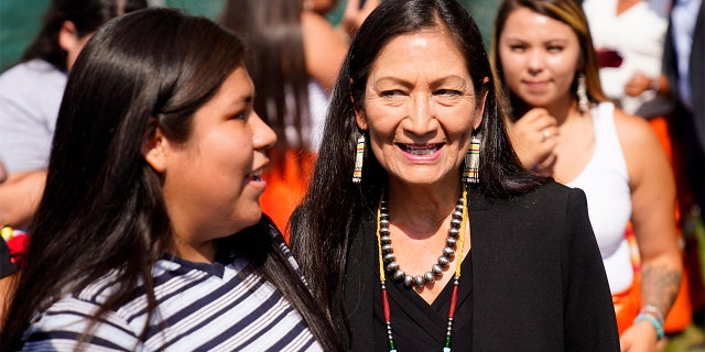 In this July 14, 2021, file photo, Interior Secretary Deb Haaland meets with young people from the Rosebud Sioux Tribe after a ceremony of the disinterred remains of nine Native American children who died more than a century ago while attending a government-run school in Pennsylvania.  (AP Photo/Matt Rourke, File)