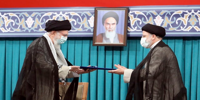 Supreme Leader Ayatollah Ali Khamenei gives his official seal of approval to newly elected President Ebrahim Raisi in an endorsement ceremony in Tehran, Iran, on Aug. 5, 2021.