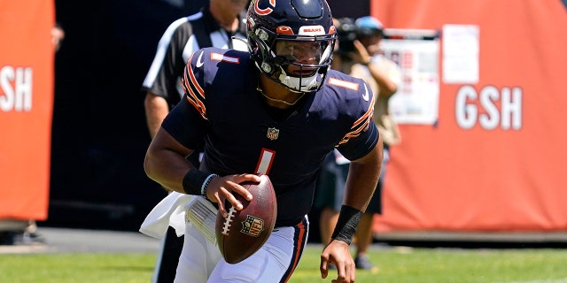 Chicago Bears quarterback Justin Fields runs with the ball during the first half of an NFL preseason football game against the Miami Dolphins in Chicago, Saturday, Aug. 14, 2021. (AP Photo/Nam Y. Huh)