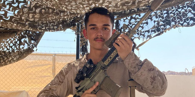 Kareem Nikoui, a young U.S. Marine, poses with his rifle. Nikoui was killed in suicide bombing in Kabul, Afghanistan, on 8/26/21