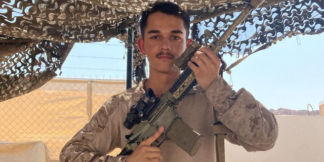 Kareem Nikoui, a young U.S. Marine, poses with his rifle. Nikoui was killed in suicide bombing in Kabul, Afghanistan, on 8/26/21