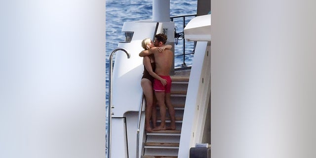 Perry donned a black one-piece swimsuit while Bloom wore red trunks.