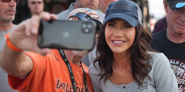 STURGIS, SOUTH DAKOTA - AUGUST 09: Governor Kristi Noem of South Dakota greets guests at the Sturgis Buffalo Chip campground after riding in the Legends Ride for charity on August 09, 2021 near Sturgis, South Dakota. (Photo by Scott Olson/Getty Images)