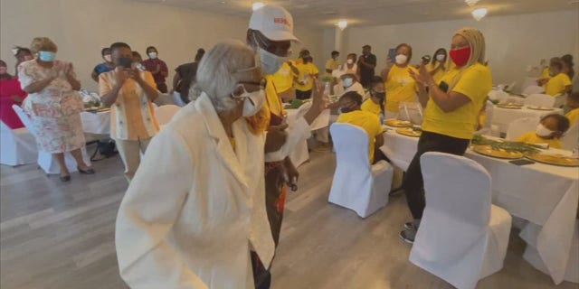 Marie Robinson took a moment to dance to the music when she entered her 100th birthday party.