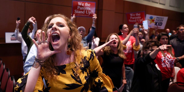 Angry parents and community members protest after a Loudoun County School Board meeting was halted by the school board because the crowd refused to quiet down, in Ashburn, Virginia, June 22, 2021.