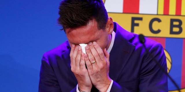 Lionel Messi cries at the start of a press conference at the Camp Nou stadium in Barcelona, ​​Spain on Sunday, August 8, 2021. FC Barcelona previously announced that negotiations with Lionel Messi are over and that Messi will leave the club.  (AP Photo / Jeanne Monfort)