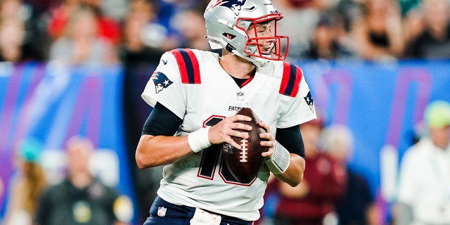 New England Patriots quarterback Mac Jones (10) drops back to pass during the second half of an NFL preseason football game against the New York Giants Sunday, Aug. 29, 2021, in East Rutherford, N.J. (AP Photo/John Minchillo)