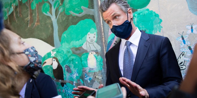 California Gov. Gavin Newsom speaks with reporters at Carl B. Munck Elementary School, Wednesday, Aug. 11, 2021, in Oakland, California. (Santiago Mejia/San Francisco Chronicle via AP, Pool)