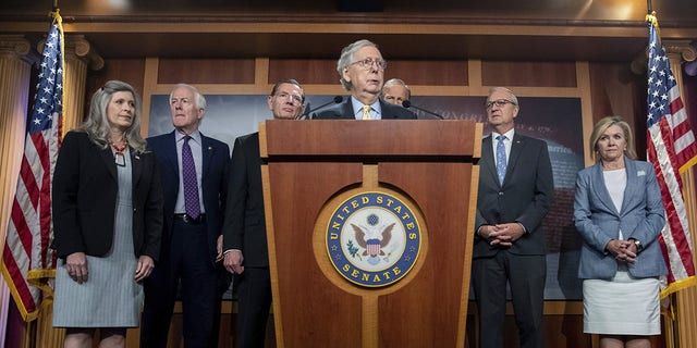 Senate Minority Leader Mitch McConnell, R-Ky., alongside other senate Republicans, speaks to members of the media on Capitol Hill in Washington, about the impact of proposed tax increases on the middle class on Wednesday, Aug. 4, 2021.