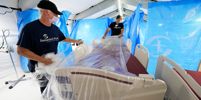 Samaritan's Purse staff set up a portable bed at a field hospital and monoclonal antibody clinic opened by the U.S. Department of Health and Human Services at the University of Mississippi Medical Center in response to the rising number of COVID-19 cases in the state. (AP Photo/Rogelio V. Solis)