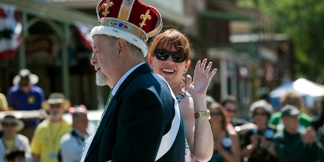 In this May 26, 2012 file photo, festival emperor Robert Ringwald of the Fulton Street Jazz Band rides with his daughter, actress Molly Ringwald, in the Sacramento Music Festival parade in Old Sacramento at Sacramento, Calif. Robert Ringwald, the pianist who has played and promoted jazz in California for more than half a century, died on Tuesday August 3, 2021, according to his daughter.  He was 80 years old.  
