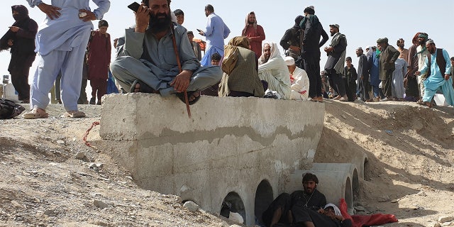 Stranded people await the reopening of the border crossing point, which was closed by authorities, in Chaman on August 7, 2021, after the Taliban took control of the Afghan border town in a swift offensive across the country.  (Photo by Asghar ACHAKZAI / AFP) (Photo by ASGHAR ACHAKZAI / AFP via Getty Images)