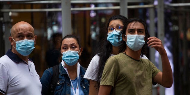 People wear a face masks in midtown Manhattan in New York on July 29, 2021.