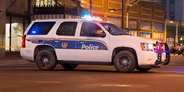 Phoenix, Arizona, USA - March 18, 2014: Police car parked blocking an avenue downtown in Phoenix.