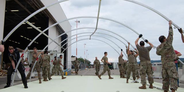 U.S. military personnel and volunteers make preparations for arriving evacuees at Ramstein Air Base in Germany. (Ramstein Air Base photo)