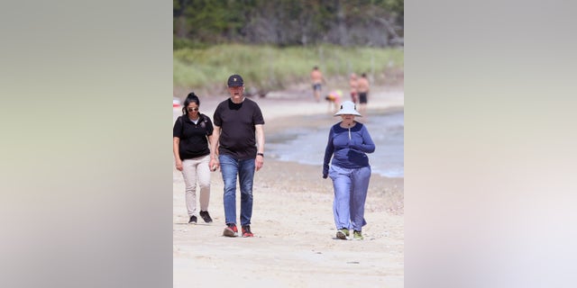 EXCLUSIVE: Bill Clinton and Hillary Clinton are spotted taking a walk along the beach near their home in The Hamptons. The couple just days ago celebrated Bill's 75th birthday, beginning down the beach, Bill dressed in jeans and a T-shirt, Hillary in sweats and a long-sleeve t-shirt and wide-brimmed hat, both wearing sneakers. They continue for about a half-mile before coming up on boardwalk where Hilary takes a break by sitting down, watched over by Secret Service Agents. Meanwhile, Bill heads up the stairs, towards what used to be the Belle Estate, and returns about 10 minutes later. The pair resume their walk another half mile with their Secret Service detail with them at all times. Pictured: Hillary Clinton,Bill Clinton Ref: SPL5248174 230821 EXCLUSIVE Picture by: Matt Agudo / SplashNews.com Splash News and Pictures USA: +1 310-525-5808 London: +44 (0)20 8126 1009 Berlin: +49 175 3764 166 photodesk@splashnews.com World Rights, No Poland Rights, No Portugal Rights, No Russia Rights