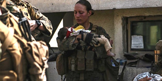 Marines assigned to the 24th Marine Expeditionary Unit (MEU) calm infants during an evacuation at Hamid Karzai International Airport, Kabul, Afghanistan, Aug. 20. U.S. service members and coalition partners are assisting the Department of State with a Non-combatant Evacuation Operation (NEO) in Afghanistan. (U.S. Marine Corps photo by Sgt. Isaiah Campbell)