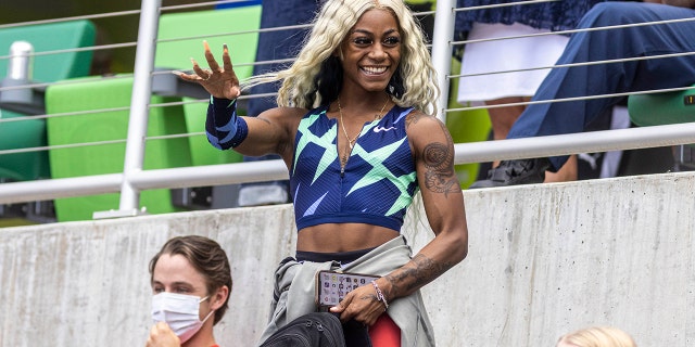 U.S. sprinter Shakarri Richardson shakes a teammate's hand from the stands after running the 100 meters at the Prefontaine Classic track and field meet, Saturday, Aug. 21, 2021, in Eugene, Ore.  (AP Photo/Thomas Boyd)