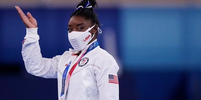 Simone Biles of the United States reacts after winning the bronze medal on the balance beam during the artistic gymnastics women's apparatus final at the 2020 Summer Olympics Aug. 3, 2021, in Tokyo, Japan.