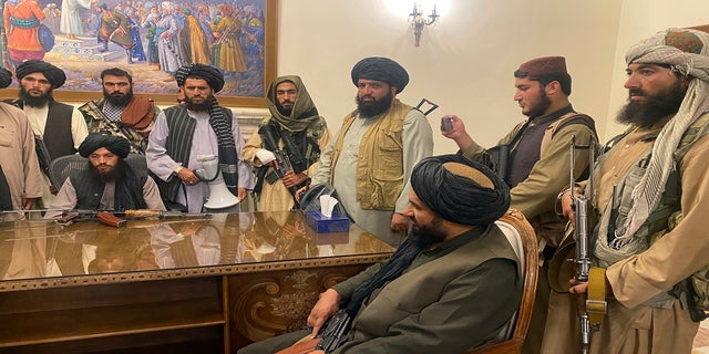 Taliban fighters take control of the Afghan presidential palace after the Afghan President Ashraf Ghani fled the country, in Kabul, Afghanistan, on Sunday.