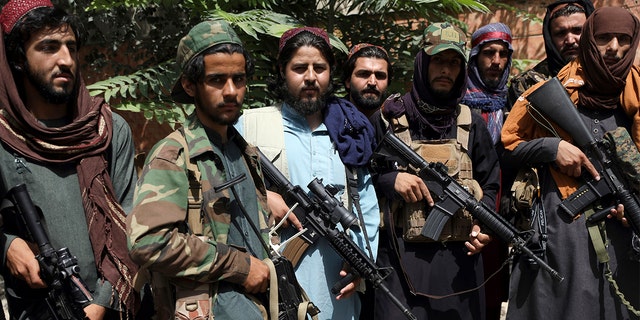 Taliban fighters pose for photograph in Kabul on Aug. 18, 2021. (AP Photo/Rahmat Gul)